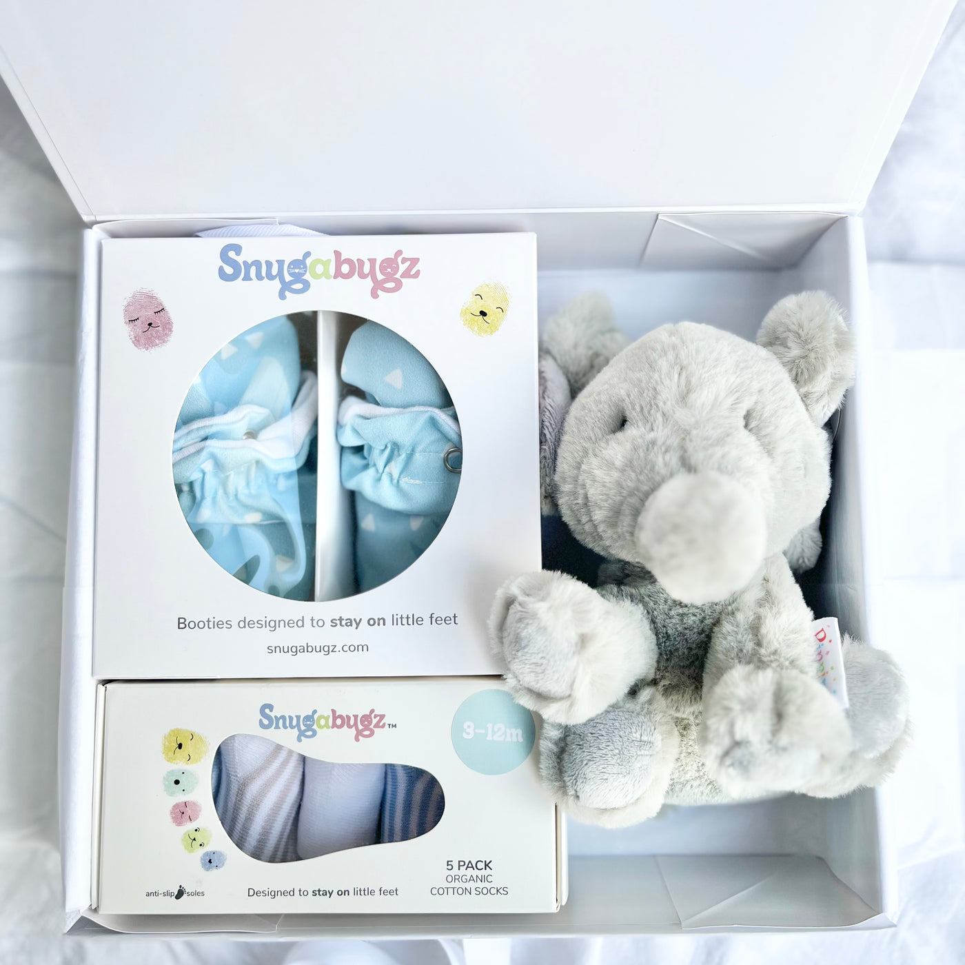 Luxury baby Gift Box Set Containing Snugabugz Blue Booties with non-slip soles and organic cotton Baby Socks That Stay On with Elephant Plush soft toy in magnetic keepsake box