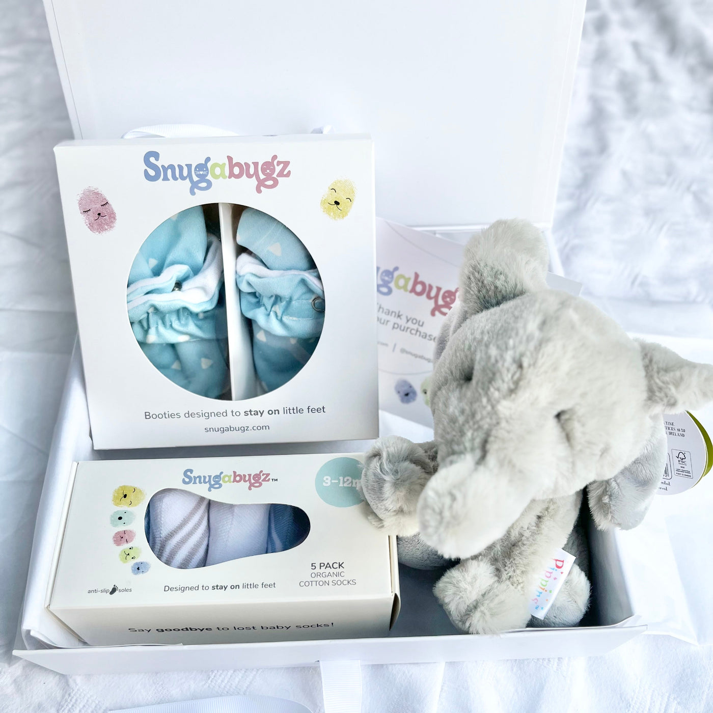 Luxury baby Gift Box Set Containing Snugabugz Blue Booties with non-slip soles and organic cotton Baby Socks That Stay On with Elephant Plush soft toy in magnetic keepsake box