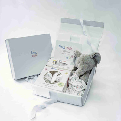 Baby gift set with elephant plush toy, stay-on baby booties, organic cotton baby socks and a gift note in a magnetic keepsake box on a white background